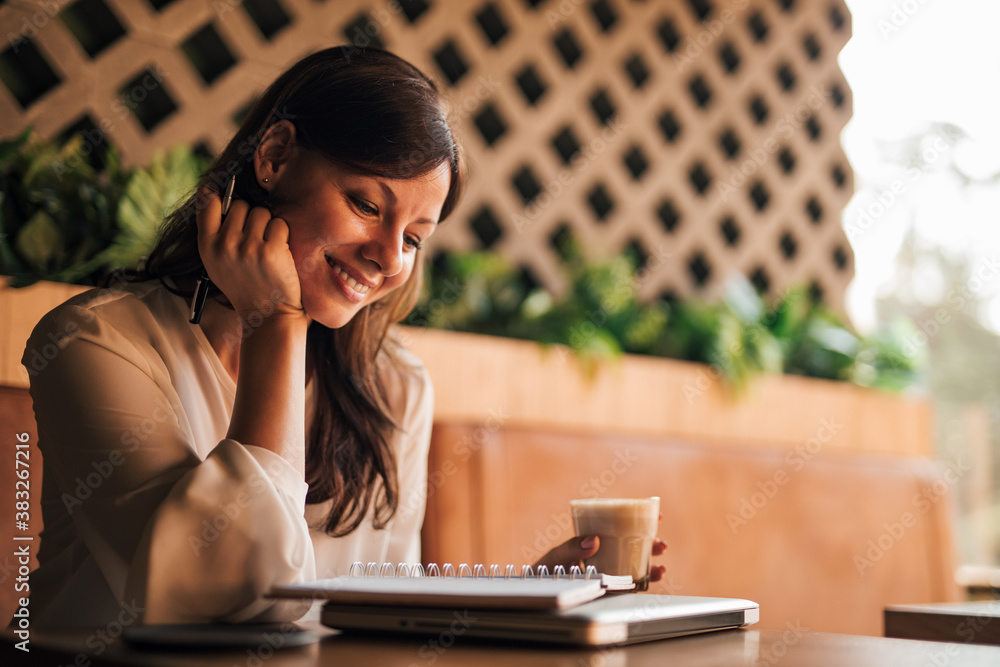 Brunette woman drinking coffee.