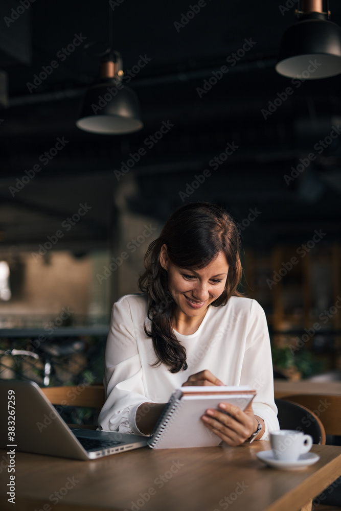 Using modern technology, sitting.