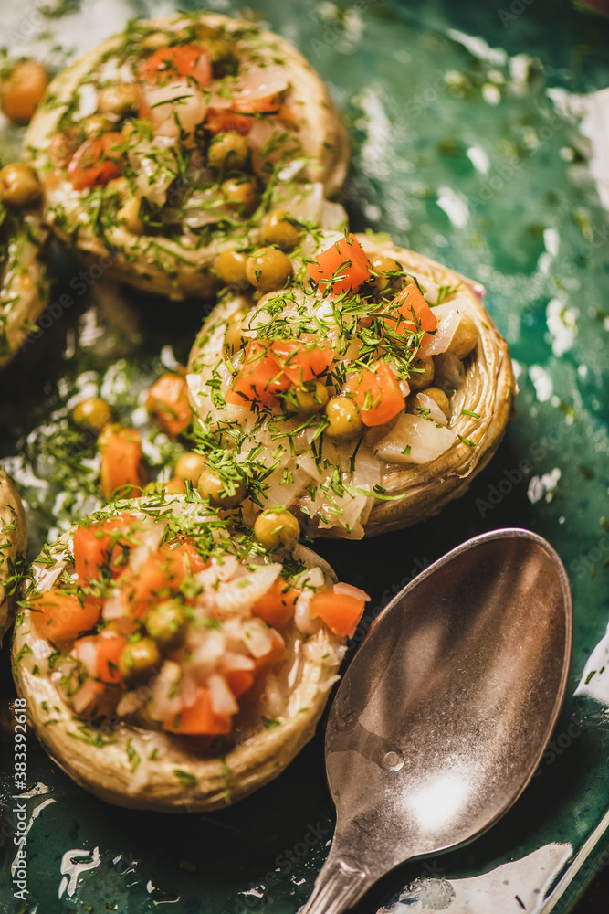 Turkish vegan artichoke salad. Artichoke bottoms filled with braised vegetables and greens with oliv