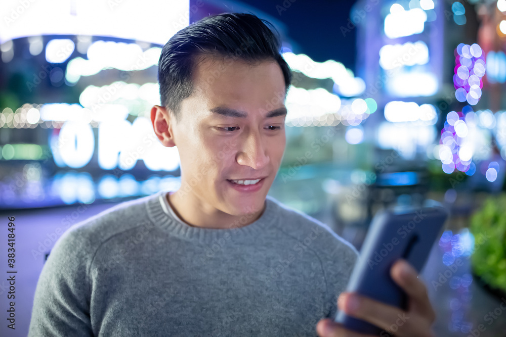 asian man use phone outdoor