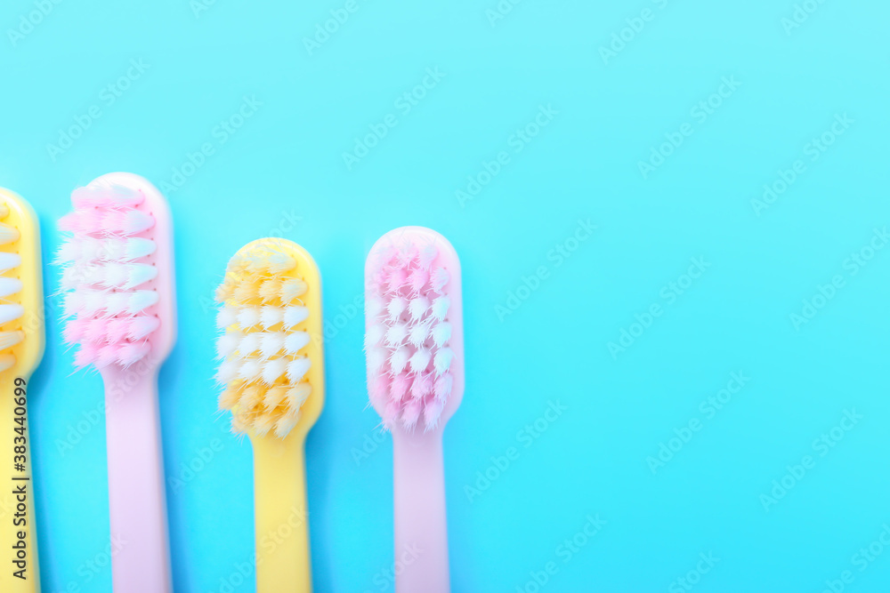 Tooth brushes on color background