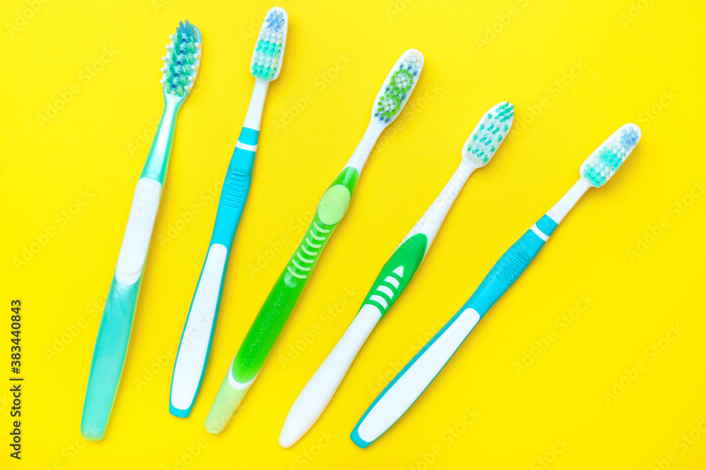 Tooth brushes on color background