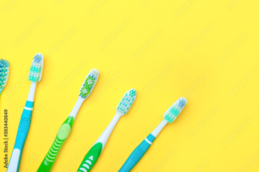 Tooth brushes on color background