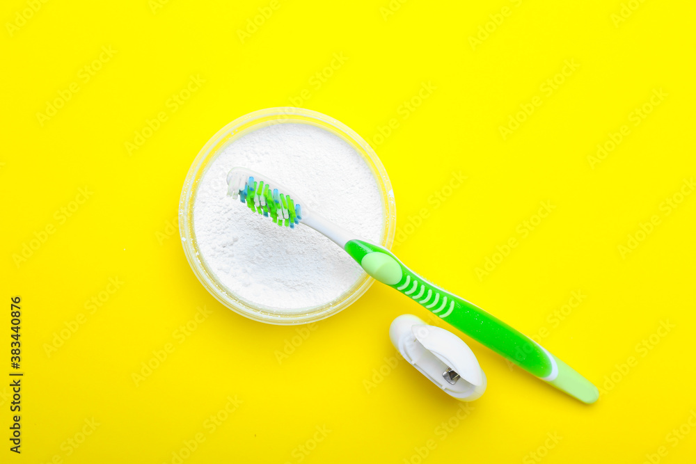 Tooth brush, powder and floss on color background