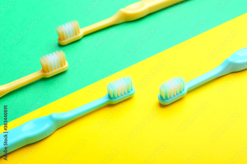 Tooth brushes on color background