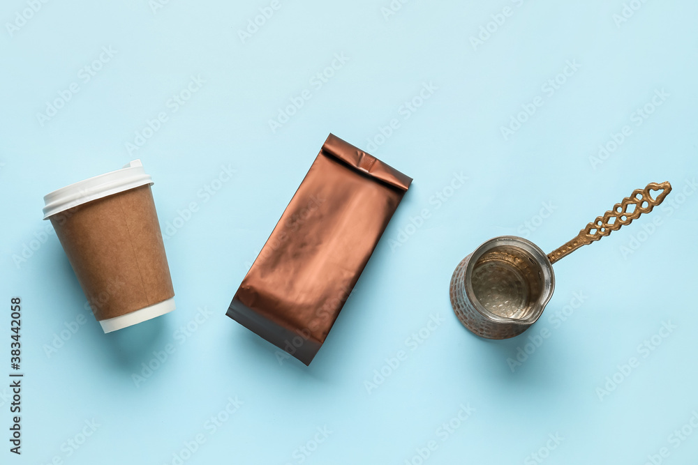 Blank bag with coffee pot and cup on color background