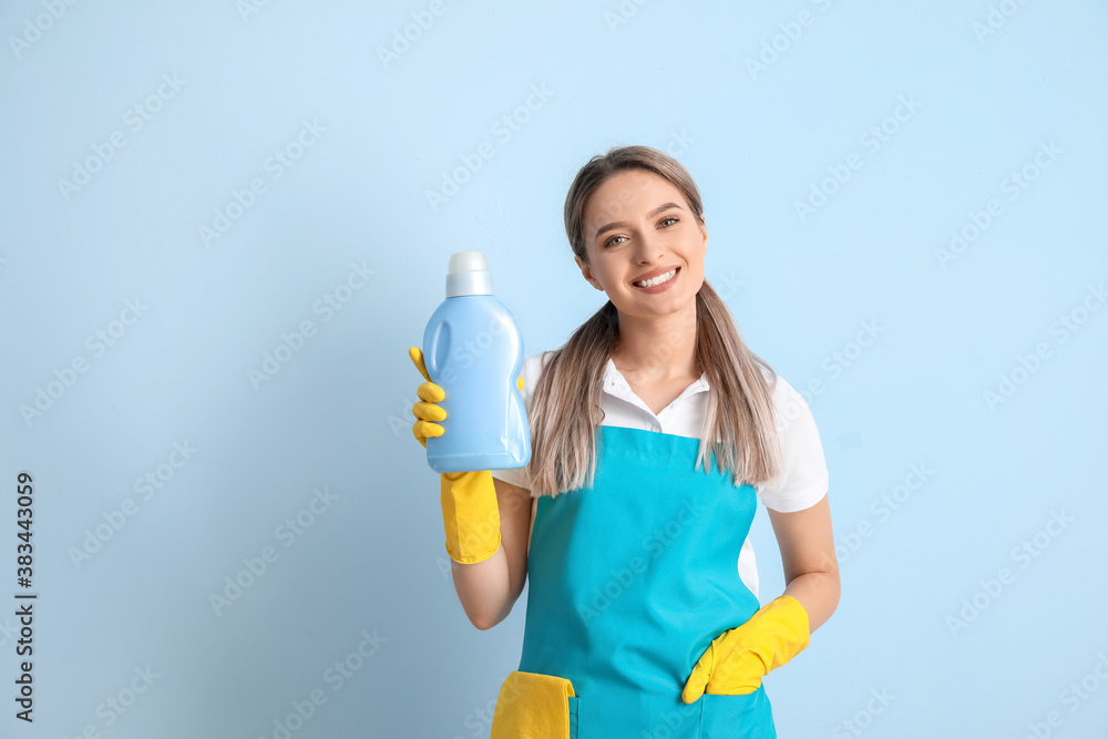 Young woman with detergent on color background