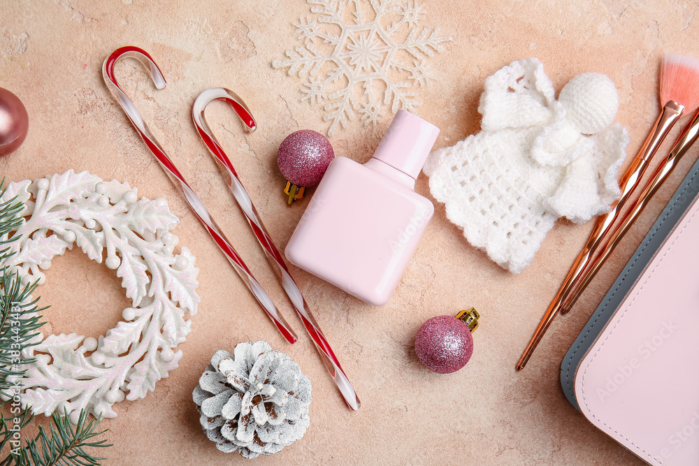 Christmas composition with cosmetics and decor on color background