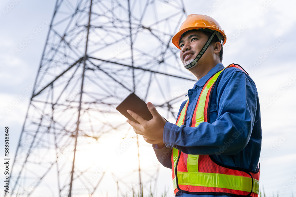 Picture of Asian engineering wear safety clothes working on High-voltage tower, Check the informatio