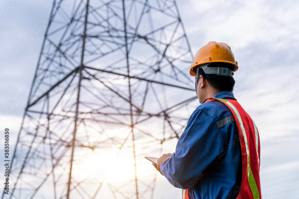 Electrical engineer wear safety clothes standing and watching at the electric power station to view 