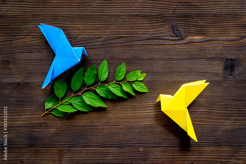 Colored origami - paper birds with leaves, overhead view