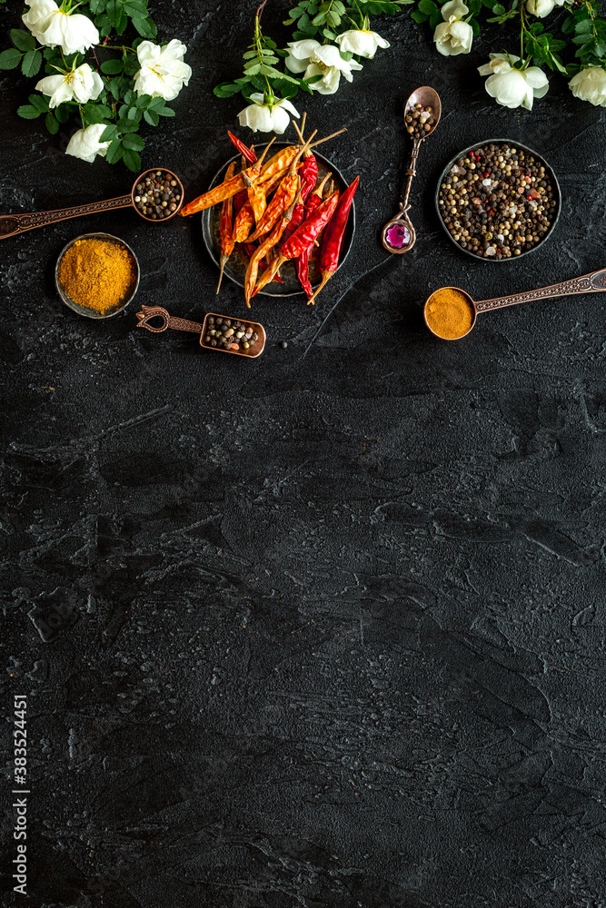 Hot spices set with herbs and flowers, top view