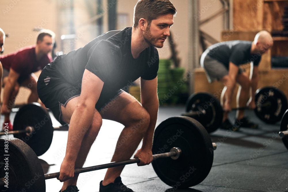 Fit young man ready for a gym weightlifting session