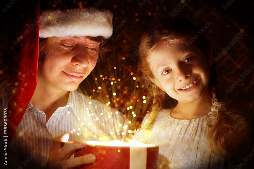 father and daughter opened a box with a gift