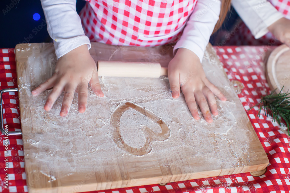 Heart drawn in flour on the board and kids hands