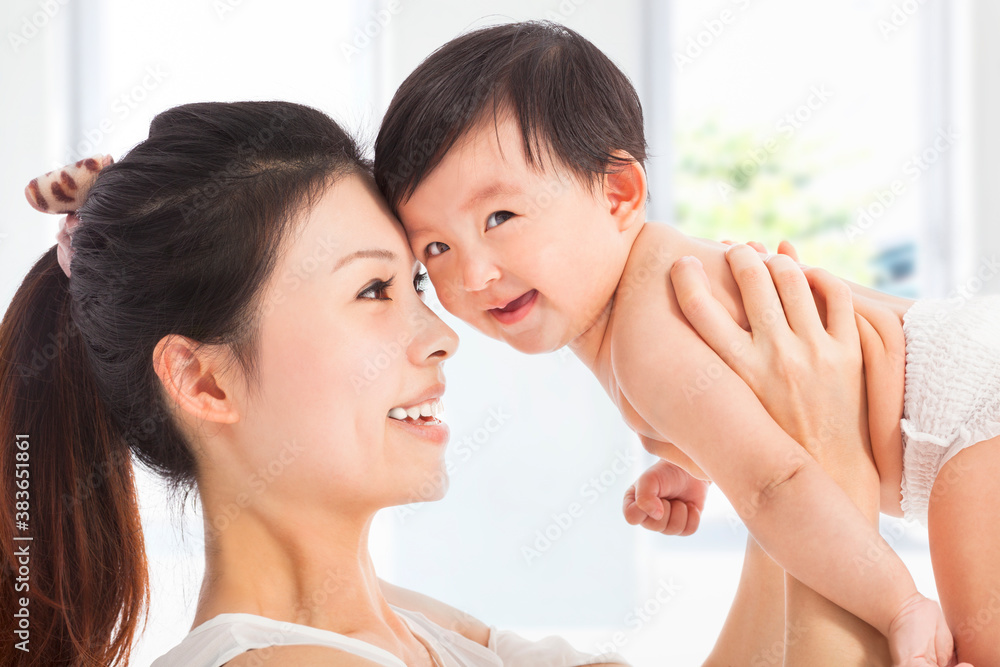 Happy  mother holding adorable child baby boy