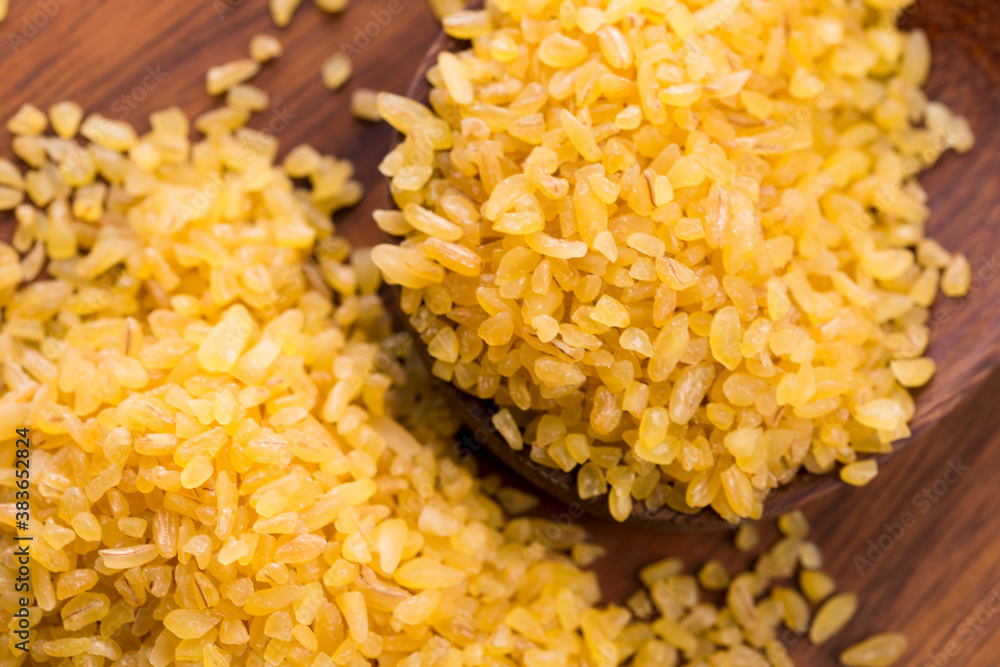 bulgur wheat in wooden spoon