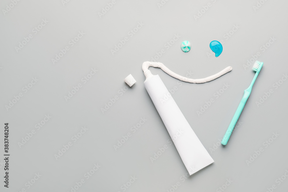 Composition with tooth brush and paste on light background