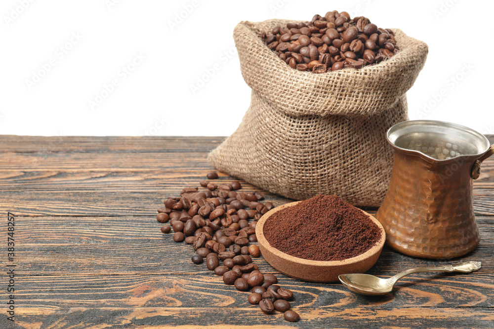 Composition with coffee beans on table against white background