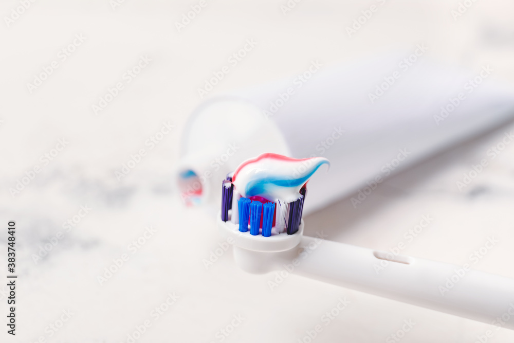 Electric tooth brush with paste on table, closeup