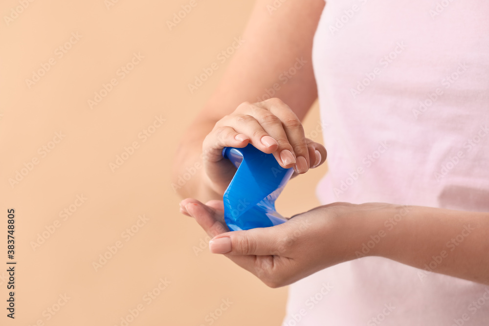 Woman crumpling plastic cup on color background. Ecology concept