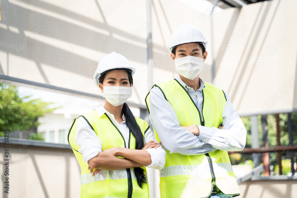 Asian young engineer man and woman wearing PPE, Protective face mask.