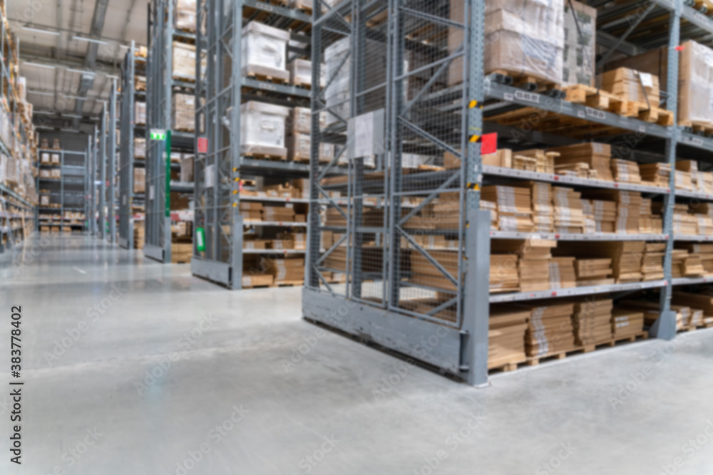 blurred background image of Rows of shelves with goods boxes in modern industry warehouse store at f