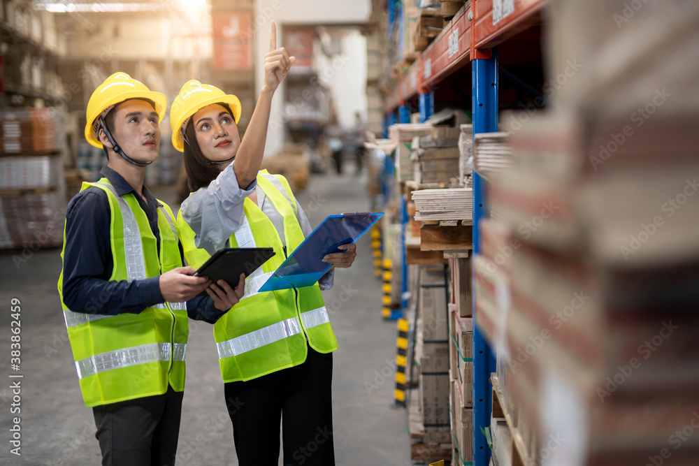 Warehouse worker working together in warehouse.