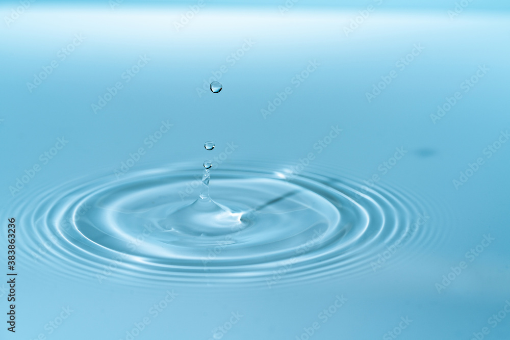 Waves on the surface of the water from a collision. Drop of water drop to the surface.