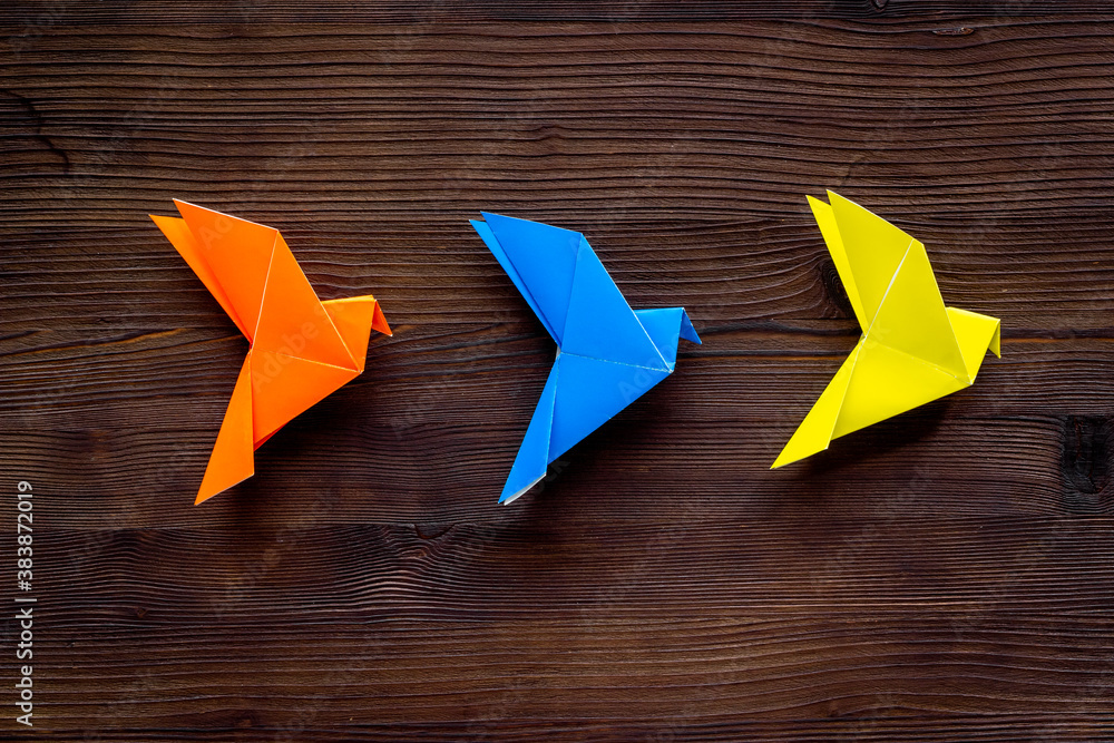 Paper birds of different shades. Origami concept. Top view