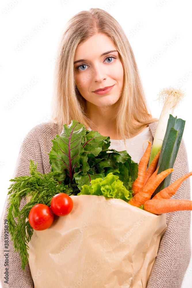 Beautiful woman carrying vegetables