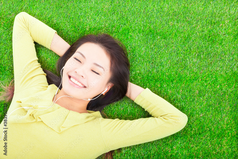 smiling  woman  holding head and lying  on a meadow