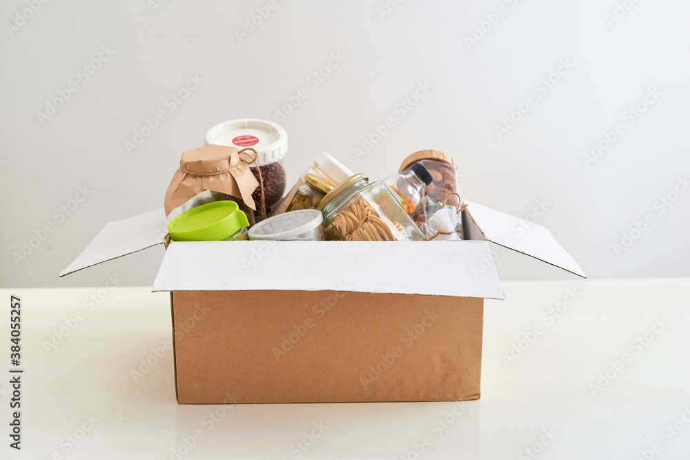 Donation box full of different products on table