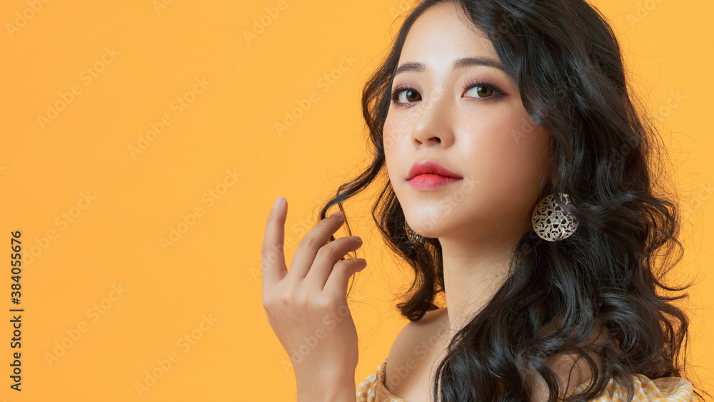 Asian woman smiling with long hair black eyes on yellow background