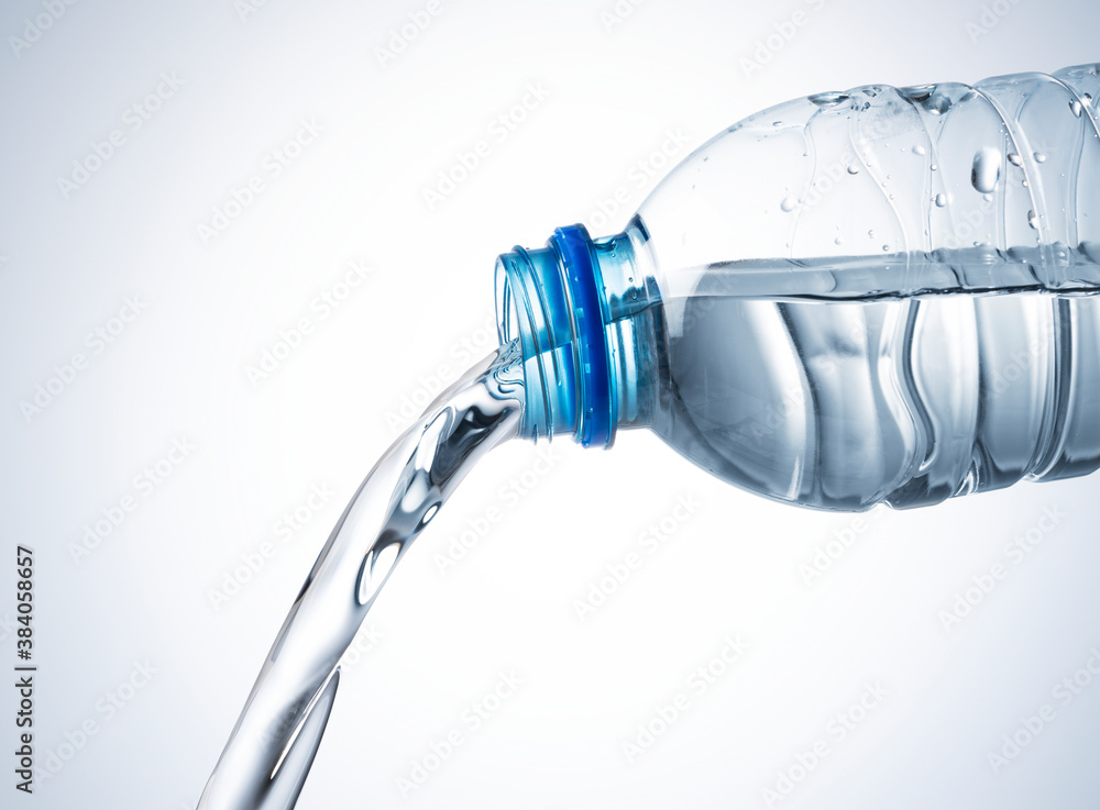 Water from a plastic bottle on a white background