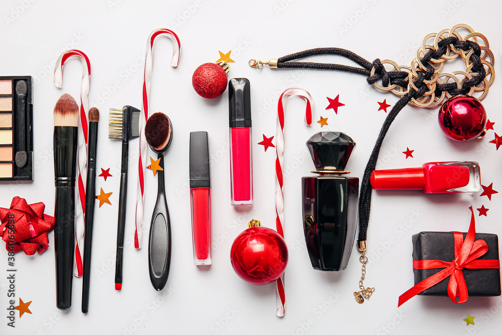 Christmas composition with cosmetics on light background