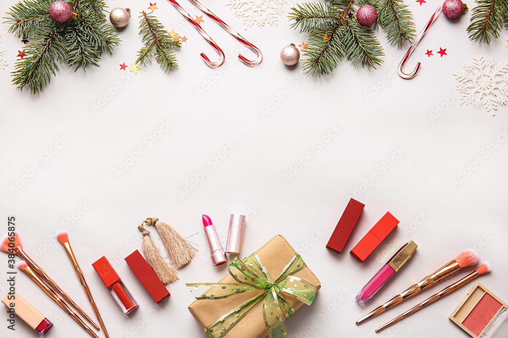 Christmas composition with cosmetics on light background