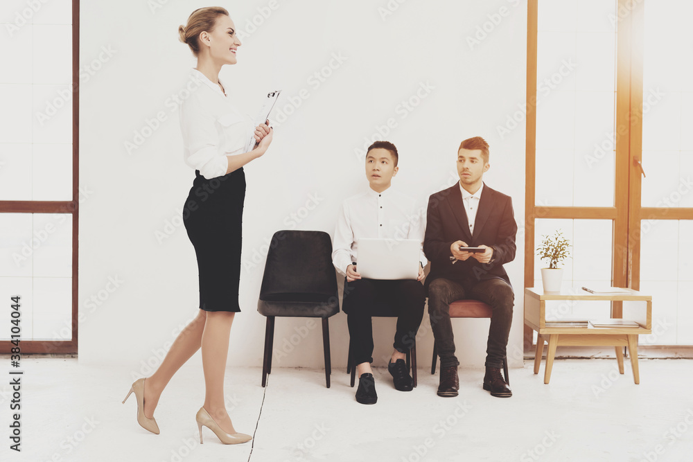 People sit in office and wait for a job interview.