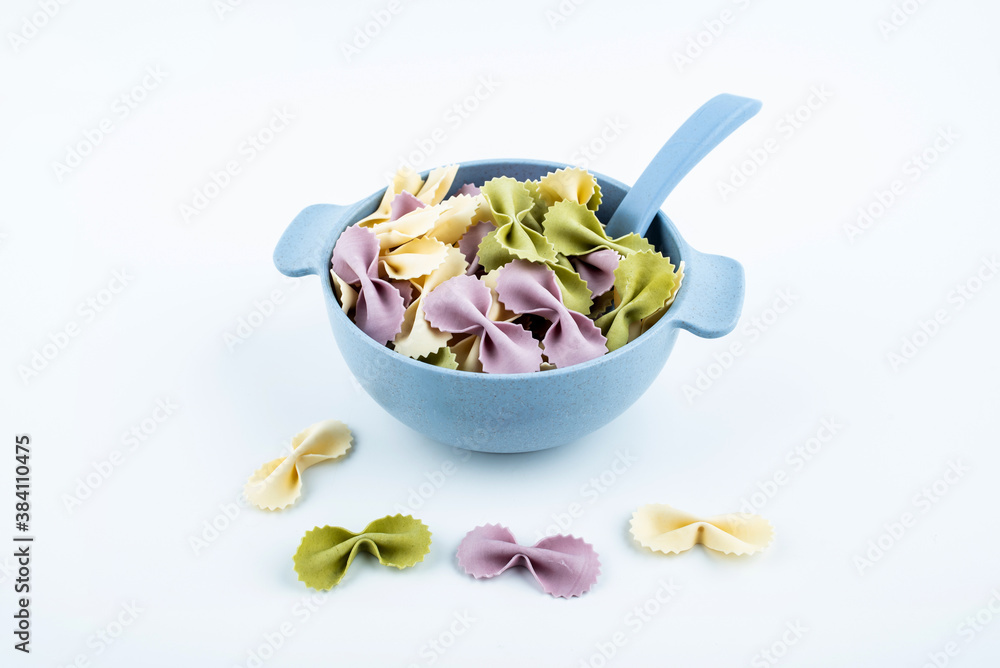 Butterfly noodles in a bowl of baby food supplement on white background