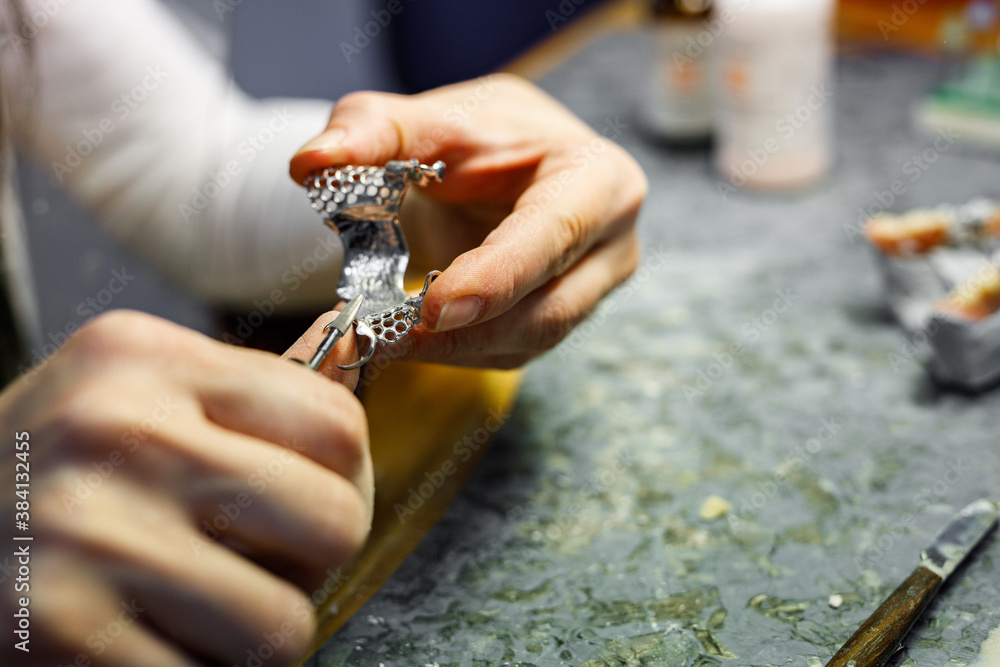 Close-up image of orthodontist working with dental equipment.