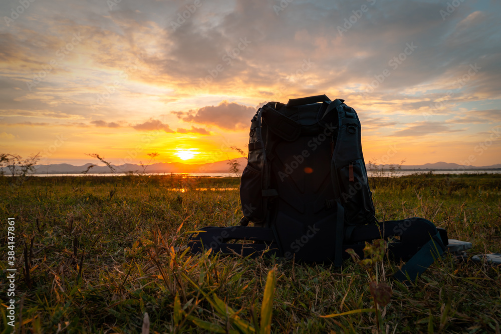 bagpack and drone with sun set