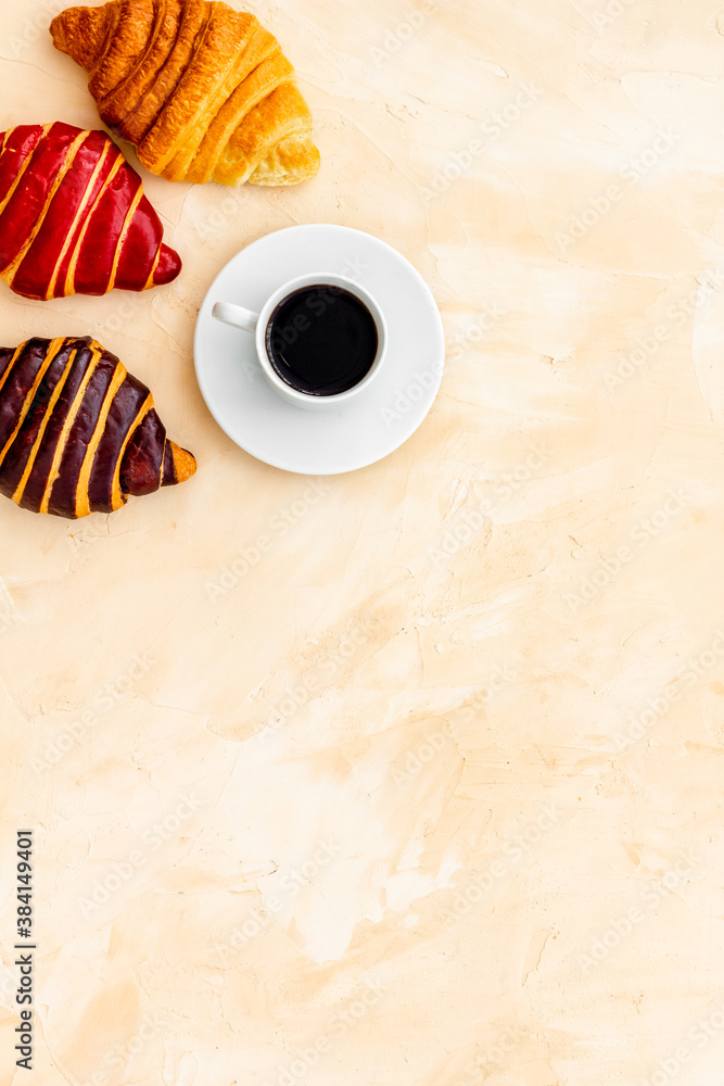 Coffee and croissants on stone table top view