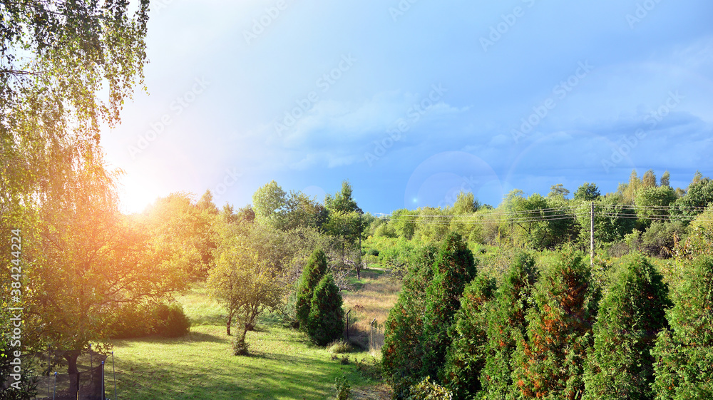 Black storm clouds during summer, Landscape with trees and meadows. Sunset.