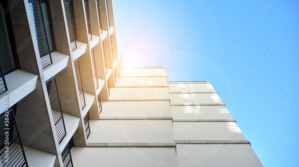 Office building, details of blue glass wall and sun reflections.