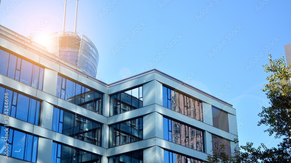 Office building, details of blue glass wall and sun reflections.