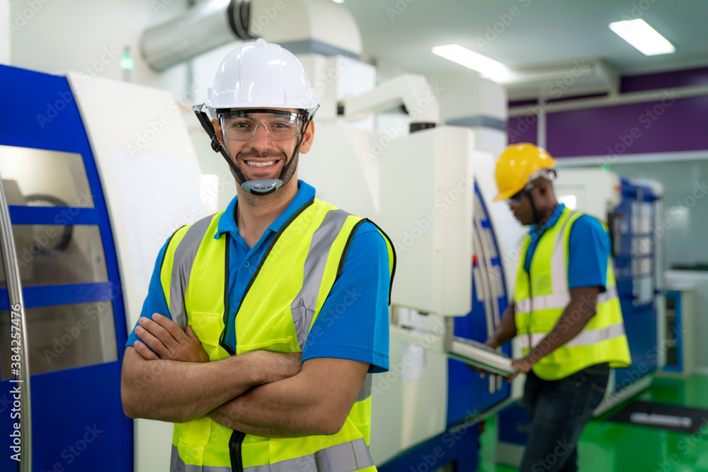 Asian engineer man wearing uniform safety workers arm crossed and perform maintenance in factory wor