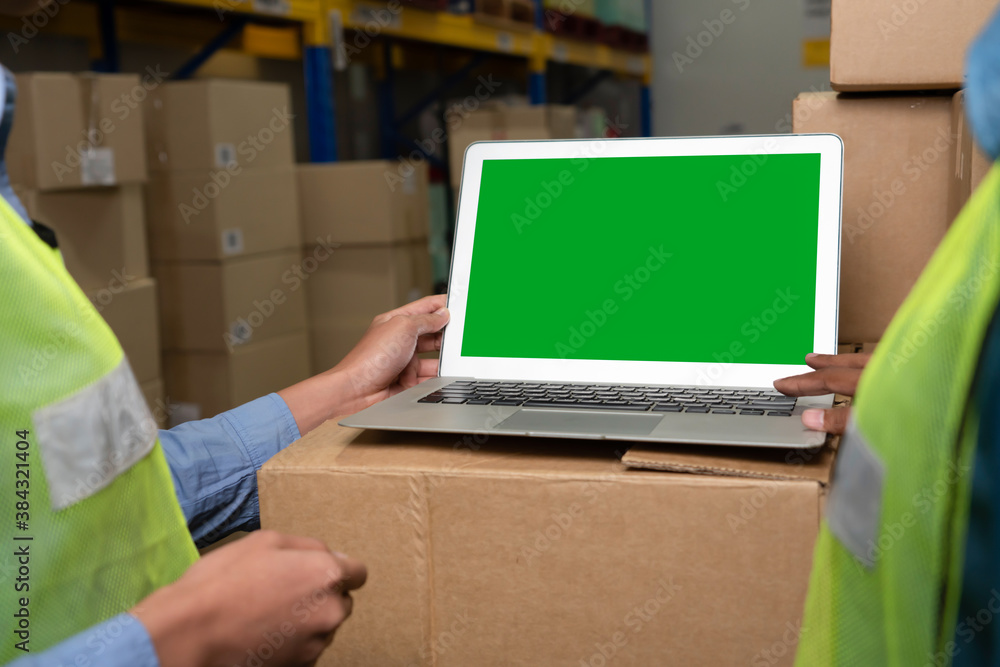 Computer with green screen display in warehouse storage room . Delivery and transportation software 