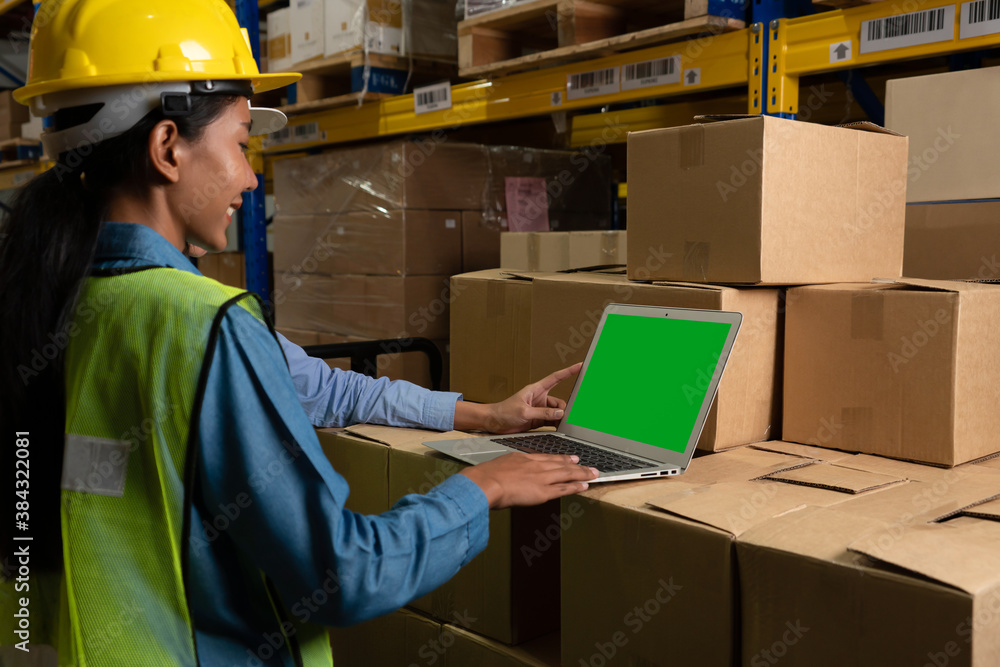 Computer with green screen display in warehouse storage room . Delivery and transportation software 