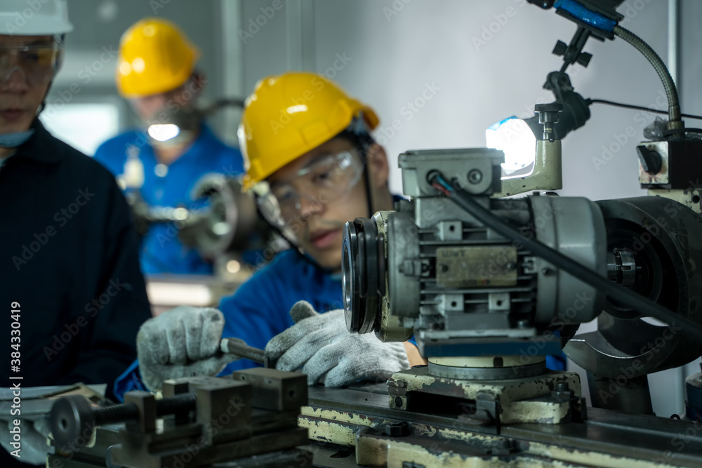 Engineer and factory worker are working on projects at machine for steel structure industry.