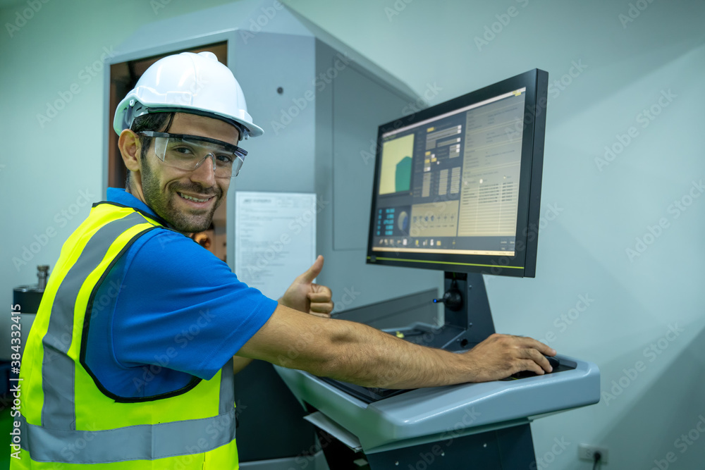 Engineer mechanic use laptop working and checking machine in a large industrial factory.